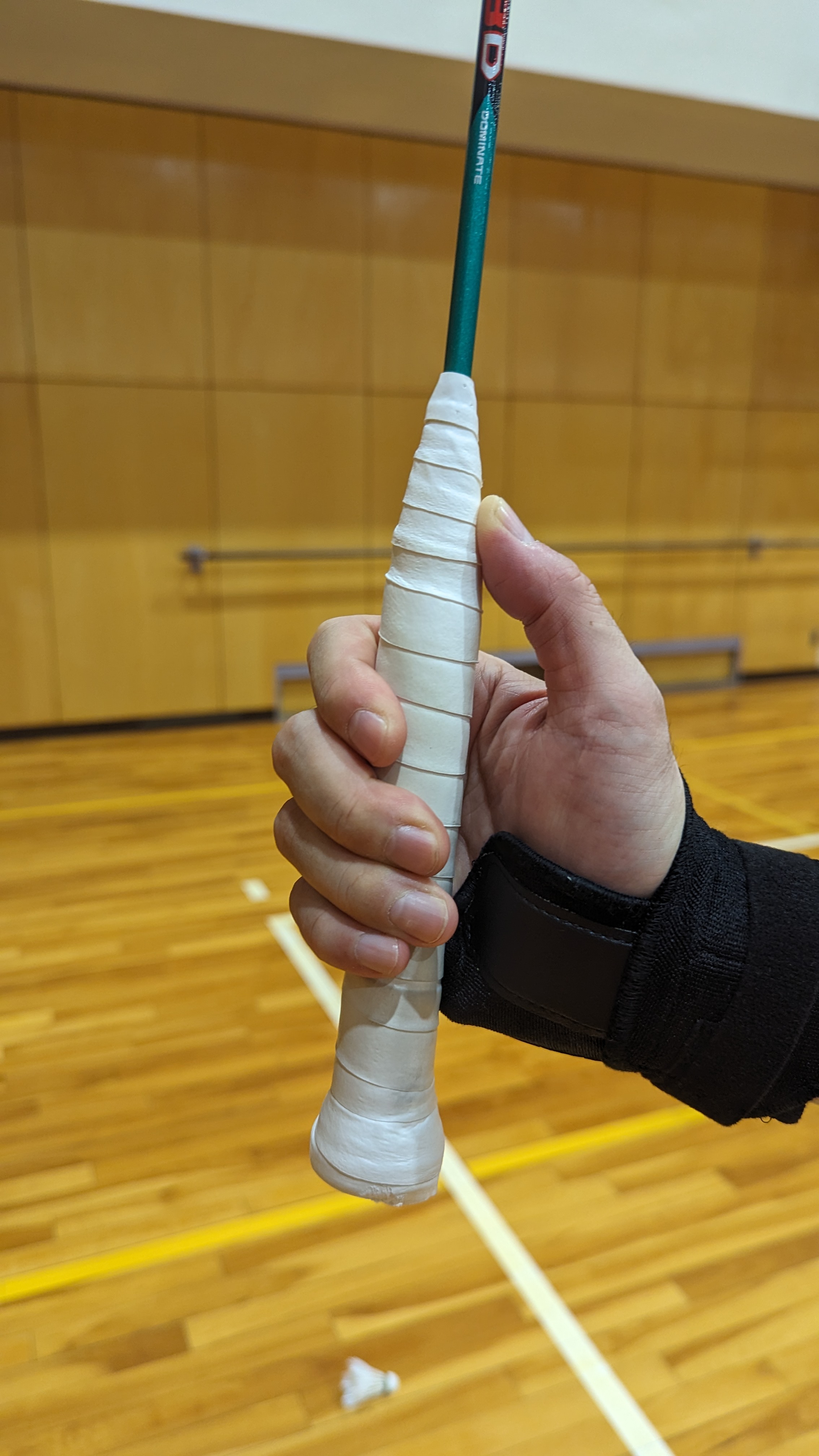 Highback Stroke Master worn while holding a badminton racket